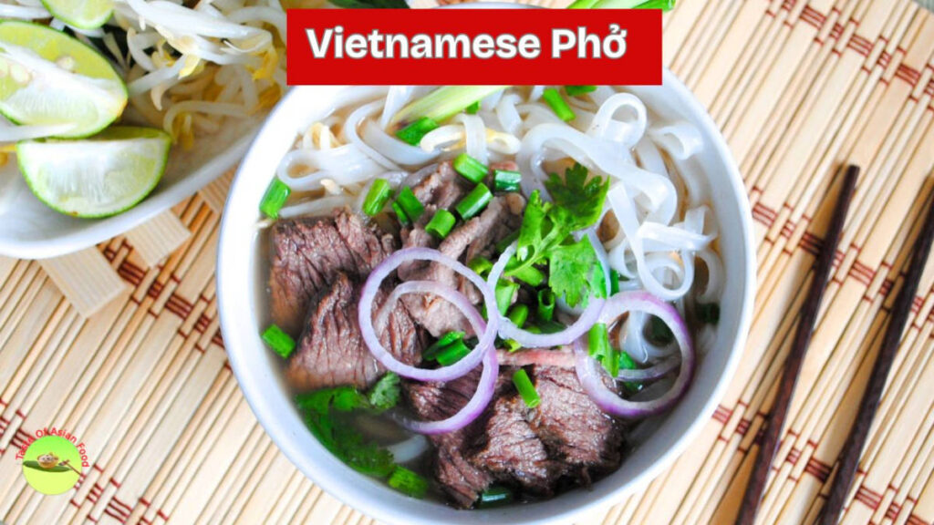 a steaming bowl of Vietnamese beef pho with clear broth tender brisket rice noodles fresh herbs and basil