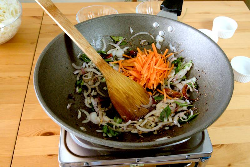 Mix the onions with the tempered spices and saute for 2 to 3 minutes until the onions become translucent. - making cabbage thoran