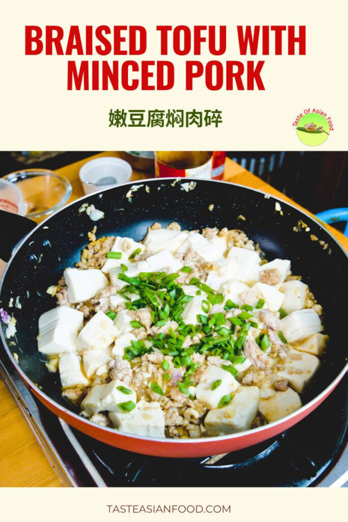 Braised silken tofu with minced pork served in a savory sauce, garnished with chopped green onions.