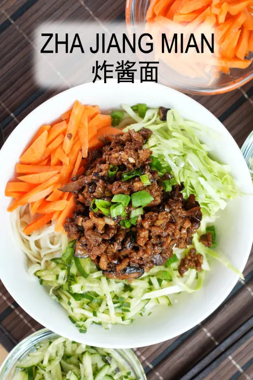 Zha Jang Mian (Beijing fried sauce noodles, 炸酱面) is prepared with made a meat sauce comprised of soybean paste 黄豆酱 and sweet bean paste 甜面酱, coupled with crunchy vegetables.
