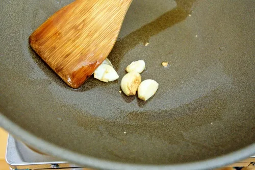 Saute the garlic cloves