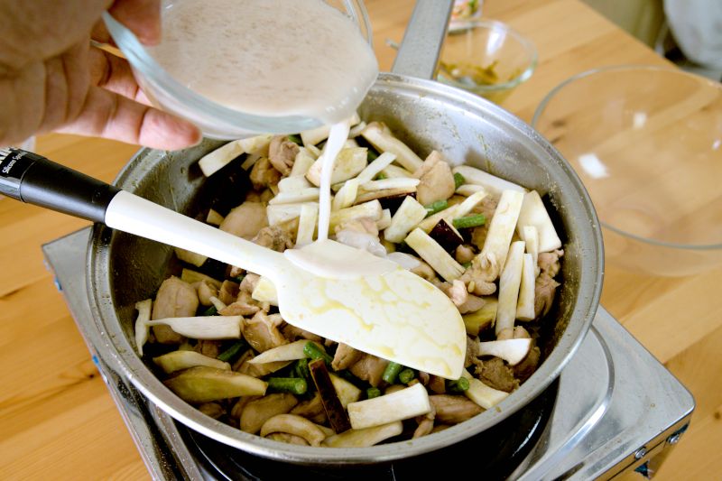 Pour the coconut cream chicken stock into the pot. 