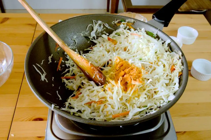 season the cabbage with turmeric powder, hing, and salt.. Cooking cabbage thoran.