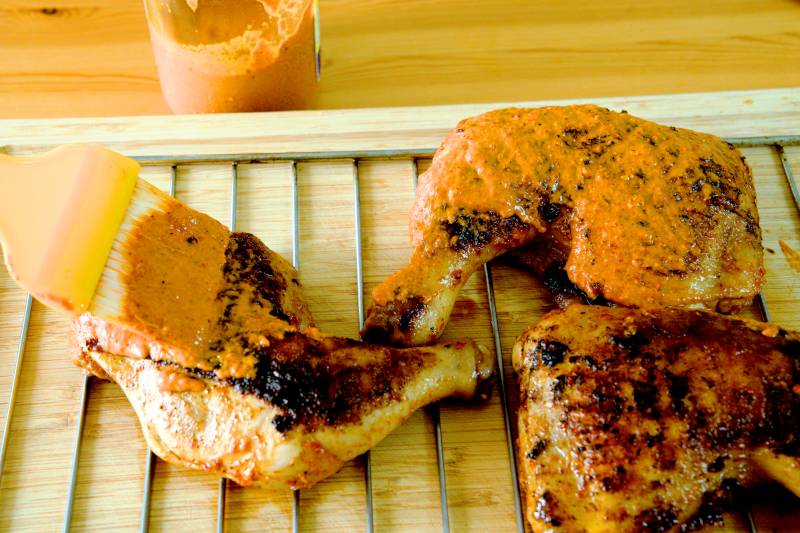 Brush the extra marinade abundantly on both sides of the chicken.