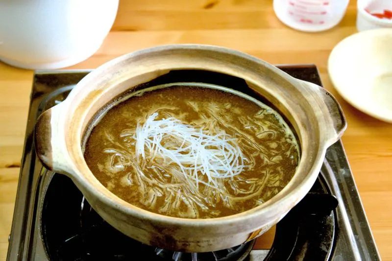 Add the glass noodles to the shrimp broth and let it simmer for one minute.