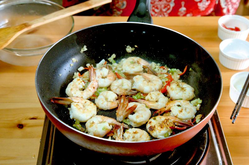 Add the shrimp to the pan and cook on both sides until they change color.