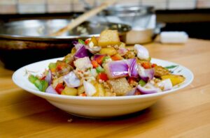 Cantonese potato and minced meat stir fry with golden potato cubes and colorful bell peppers, served hot