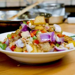 Cantonese potato and minced meat stir fry with golden potato cubes and colorful bell peppers, served hot