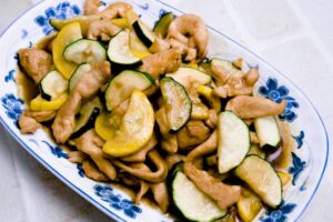 Stir-fried zucchini with chicken in a savory garlic soy sauce, featuring tender chicken pieces and crisp zucchini slices