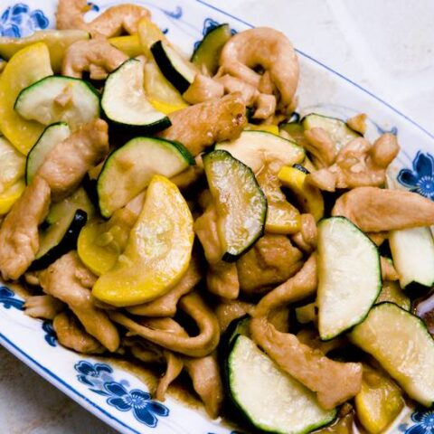 Stir-fried zucchini with chicken in a savory garlic soy sauce, featuring tender chicken pieces and crisp zucchini slices