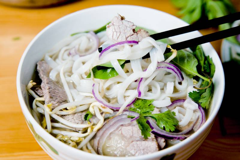 homemade Vietnamese pho with tender beef slices aromatic broth rice noodles and fresh basil and bean sprouts